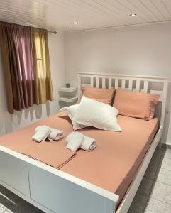 un grande letto con due cuscini bianchi di Neochori Studio a Karpathos