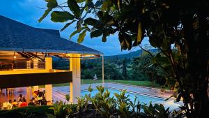 a view of a building with a swimming pool at Commune18 Resort Chikmagalur in Chikmagalūr