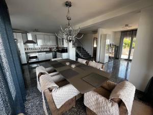 a dining room and kitchen with a table and chairs at Villa Sanja I in Trogir