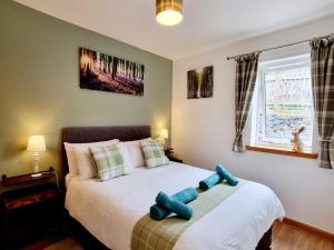 a bedroom with a bed with a blue toy on it at Hill View 2 bedroom in Inverness