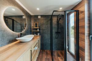 a bathroom with a sink and a shower at Salnēni in Vecpiebalga