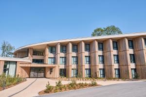 um edifício de escritórios com um telhado curvado em LOISIUM Wine & Spa Hotel Champagne em Mutigny