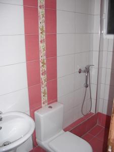a bathroom with a toilet and a sink at Aris House in Paralia Katerinis