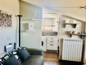a living room with a couch and a kitchen at Carolina’S Nest in Casal Palocco
