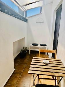 a room with a wooden table and a bench at Carolina’S Nest in Casal Palocco
