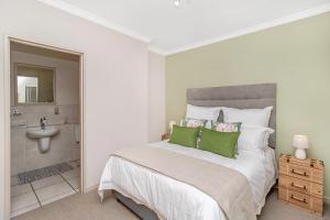 a bedroom with a large bed and a bathroom at West Point Properties in Johannesburg