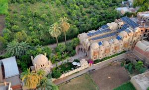 an aerial view of a large building with a garden at Embrace Hotel in Luxor