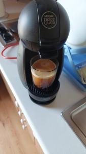 a coffee maker sitting on a counter with a cup of coffee at Cabañas Montes Universales in Orihuela del Tremedal