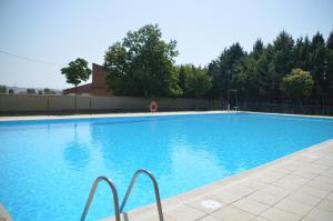 a large swimming pool with blue water at La Casa del Campillo in Baltanás