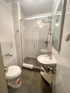 a bathroom with a shower and a toilet and a sink at Apartments Arena in Pula