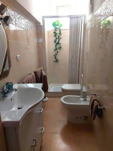 a bathroom with a white sink and a toilet at Casa Vacanze Bei Ricordi in Reggio Calabria