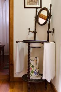 a mirror and a vase on a stand in a room at Casa Rural La Gañanía in Los Realejos