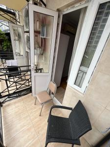 a balcony with a chair and a table and chairs at Hotel Dolphin Batumi in Batumi