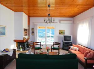 a living room with a couch and a table at Nirvana Guest House in Vasilítsion