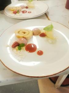 a white plate with food on a table at Wisingsö Hotell in Visingsö