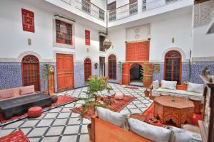 a living room with a couch and a table at Riad Dar Jeanne in Fez