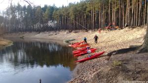 un groupe de kayaks bordés sur la rive d'une rivière dans l'établissement Apartament River Skierniewice, à Skierniewice