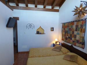A bed or beds in a room at Hotel Rural Bioclimático Sabinares del Arlanza