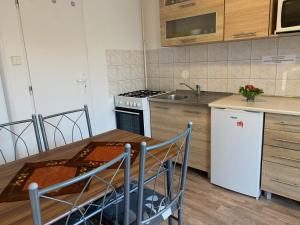 cocina con mesa y nevera blanca en ubytovanie OPÁL en Štúrovo
