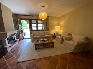 a living room with couches and a coffee table at Casas El Castañedu in Niembro