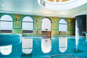 una piscina con una fila di finestre in un edificio di Crowne Plaza Jordan Dead Sea Resort & Spa, an IHG Hotel a Sowayma