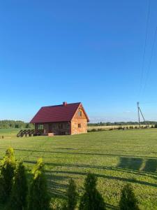 a barn in a field next to a large field at Bareišių sodyba in Moškėnai +11 photos