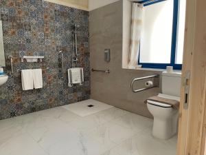 a bathroom with a toilet and a sink at Fiftyfour West Boutique Living in Għarb