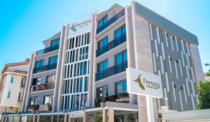 a building with a sign in front of it at Peramis Hotel & Spa in Antalya