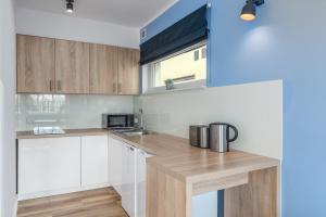 a kitchen with white cabinets and a counter top at Statki Na Niebie in Rowy