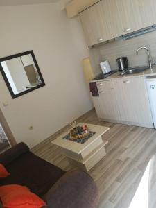 a living room with a couch and a kitchen at Apartment Privat in Sunny Beach in Sunny Beach