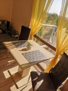 a table with a laptop on it in a living room at Apartment Privat in Sunny Beach in Sunny Beach