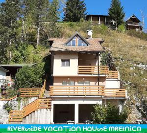 a house on the side of a hill at Riverside Vacation House Mrežnica in Donji Zvečaj