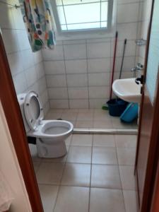 a bathroom with a toilet and a sink at Apartamente Gleni in Sarandë +15 photos