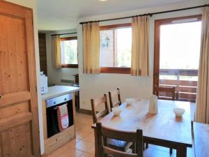 a kitchen and dining room with a table and chairs at Appartement Morillon 1100, 3 pièces, 6 personnes - FR-1-412-5 in Morillon