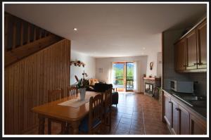 a kitchen and dining room with a table and a couch at Mas Meya in Puigcerdà