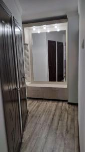 a room with a large mirror and a hallway at Apartment near Farkhadskiy bazar in Tashkent