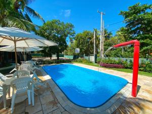 a swimming pool with a water slide in a yard at Chalés Praias do Sul in Porto De Galinhas