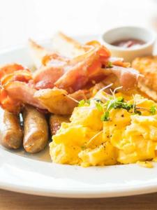 a plate of food with scrambled eggs and bacon at Fernydale Farm Bed & Breakfast in Earl Sterndale