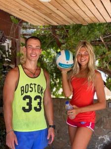 a man and a woman standing next to a volleyball at CAMP&HOSTEL Antalya in Antalya