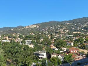 a town on a hill with houses and trees at Studio Cannes Marina Mandelieu in Mandelieu-la-Napoule