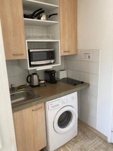 a kitchen with a washing machine and a sink at Studio Cannes Marina Mandelieu in Mandelieu-la-Napoule