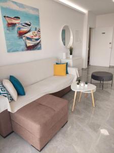 a living room with a couch and a table at Amazing Napa Apartment in Ayia Napa
