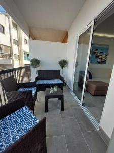 a balcony with a couch and a table on a balcony at Amazing Napa Apartment in Ayia Napa