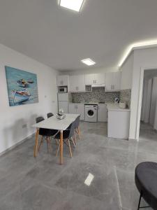 a kitchen with a table and chairs in a room at Amazing Napa Apartment in Ayia Napa