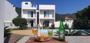 a table with a plate of food and a bottle of beer at Quinta do Lapa in Florianópolis
