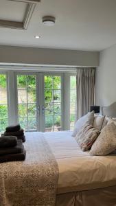 a bedroom with a large bed with windows at Annex Fishers Yard in York