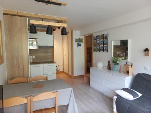 a living room and kitchen with a table and a couch at Studio Tignes, 1 pièce, 4 personnes - FR-1-449-72 in Tignes
