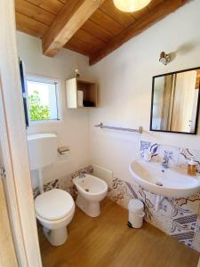 a bathroom with a toilet and a sink at B&B Pelagos in Castellammare del Golfo +34 photos