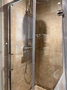 a shower with a glass door in a bathroom at Annex Fishers Yard in York