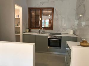 a kitchen with a sink and a stove at Six bedroom Holiday home Matea in Ploče +48 photos
